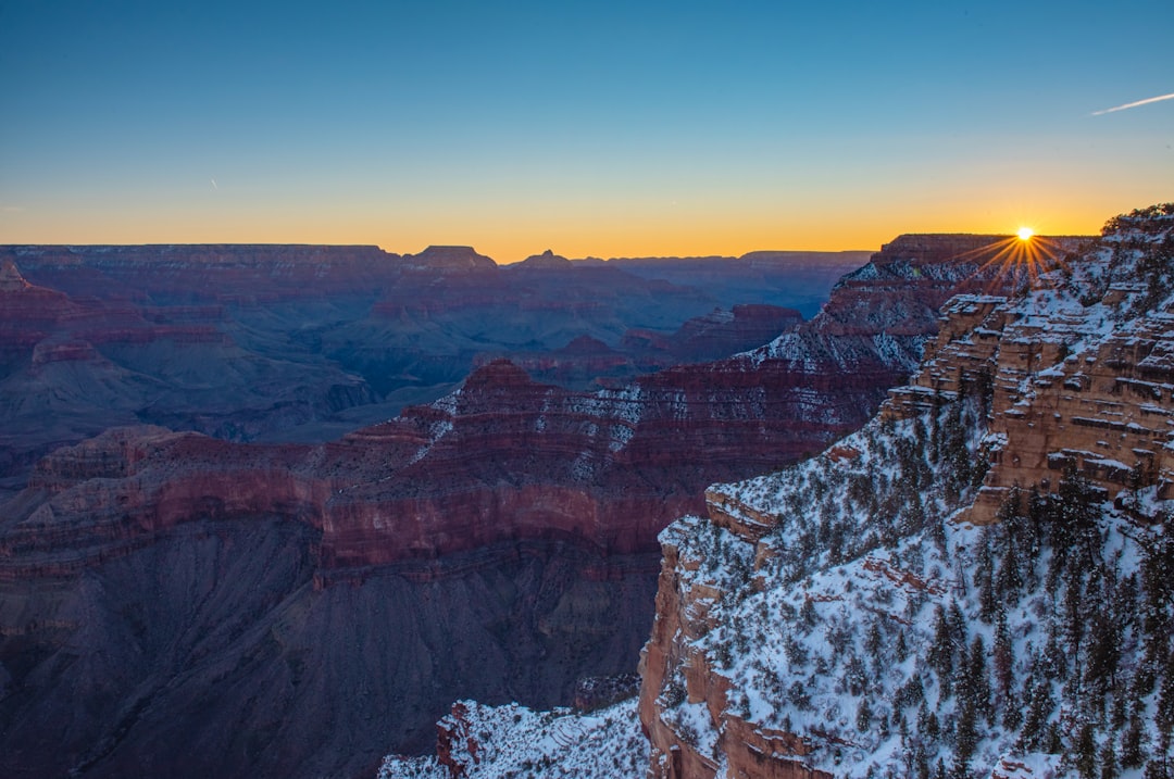 Sun setting over the rim of the Grand Canyon