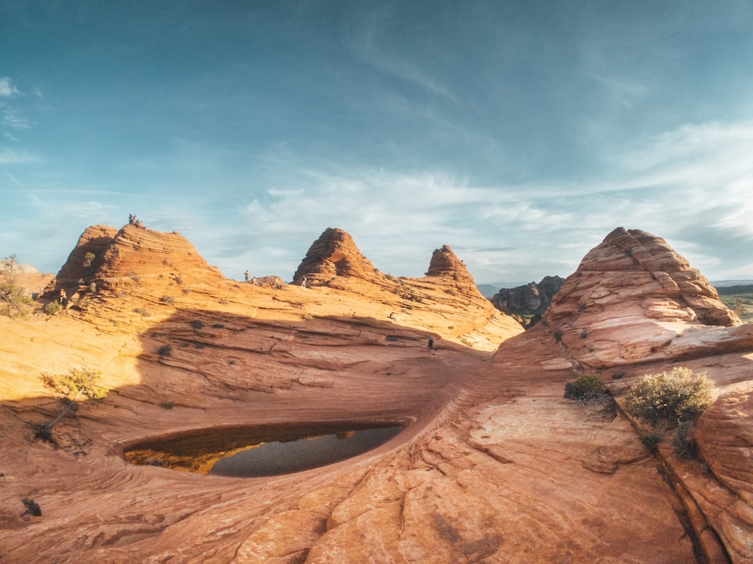 Red rock canyon formations at Zion National Park, Utah — towering sandstone walls under a clear blue sky