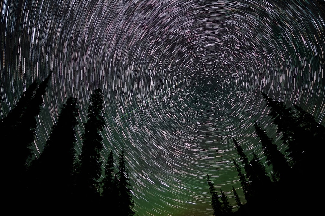 Star trail night sky over a dark landscape