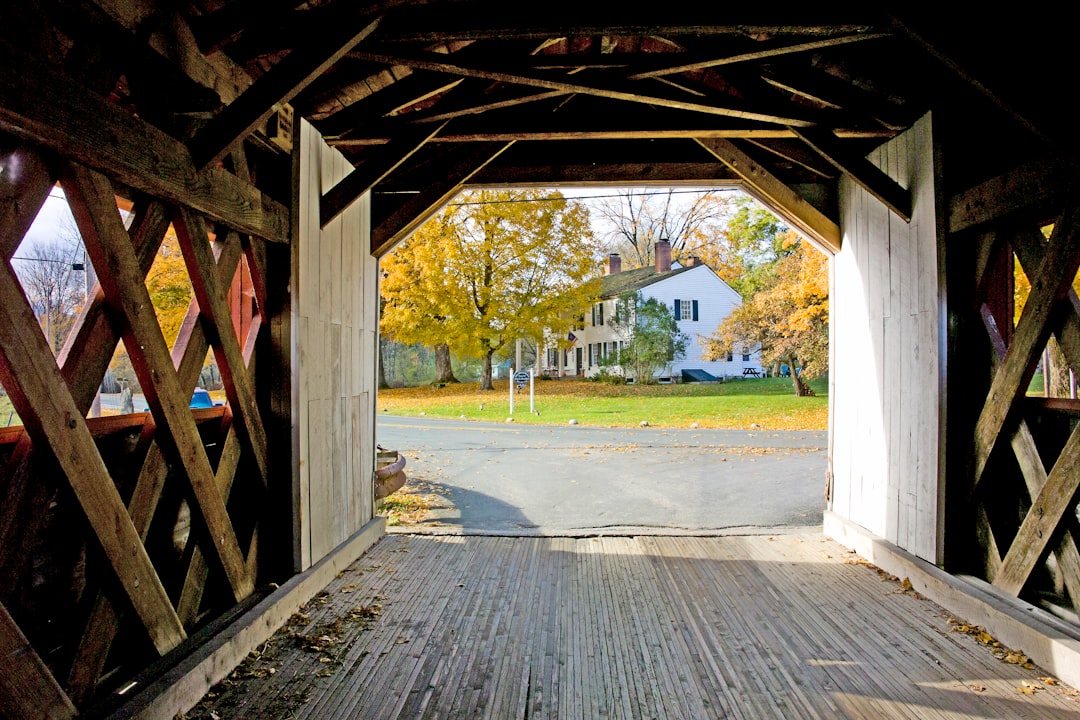 A classic New England covered bridge framed by autumn foliage