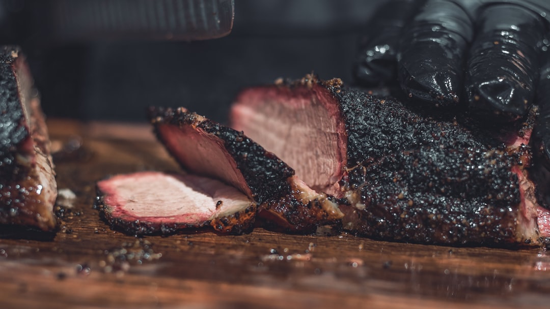 Sliced smoked brisket on a wooden board